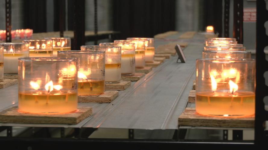 Candles burn in factory at Mayfield factory in Hickory, Ky.