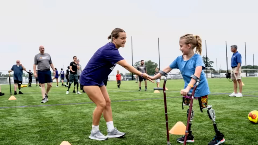 Racing Louisville player helps young girl on crutches