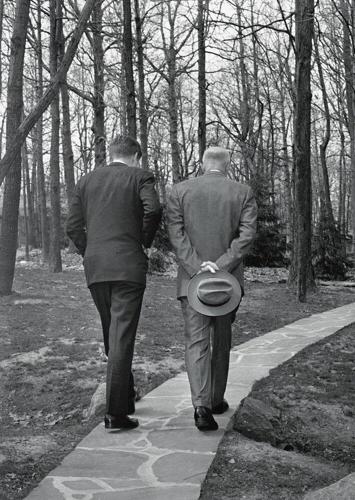 John F. Kennedy walks with Dwight D. Eisenhower