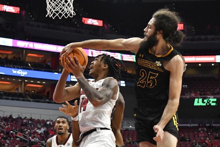 Southeastern Louisiana guard Joe Kasperzyk blocks a shot by Dre Davis.jpeg