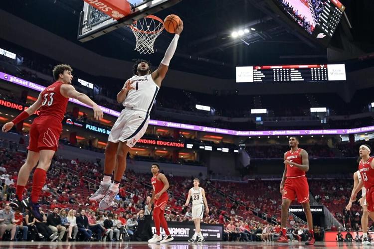 Virginia forward Jayden Gardner goes up for a shot past Louisville forward Matt Cross.jpeg