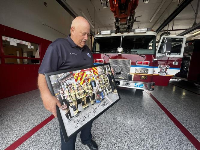 Rich Carlson at Zoneton Fire holds up photo of first movie scene with department