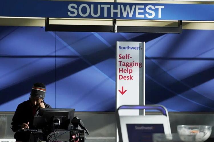 A person works behind the Southwest Airlines ticket counter.jpg