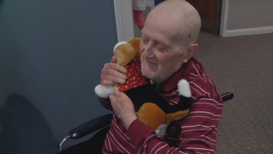 Senior with stuffed puppy brought by Pearl's Memory Babies