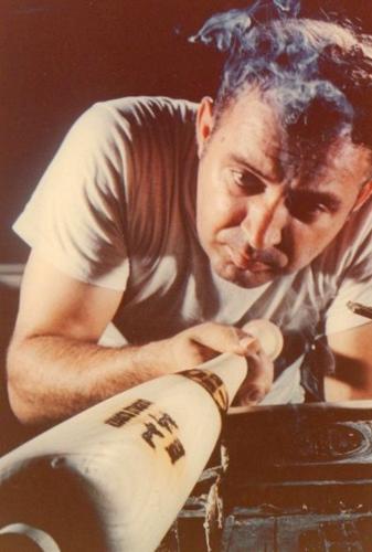 Unidentified Hillerich & Bradsby Co. employee manufacturing a metal bat (color pic)