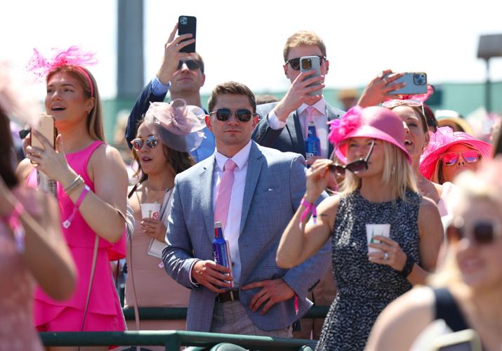 Fans record race with phone.JPG