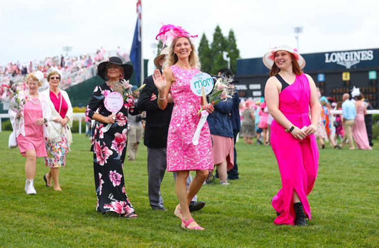 Mother holds up sign at Kentucky Oaks Survivors Parade.JPG