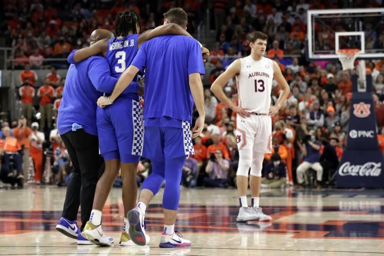 Kentucky guard TyTy Washington Jr. is helped off the court against Auburn
