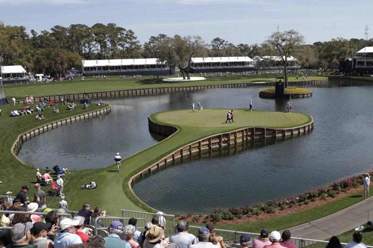 Cameron Champ, Nate Lashley, Kevin Tway and their caddies, walk the 17th green
