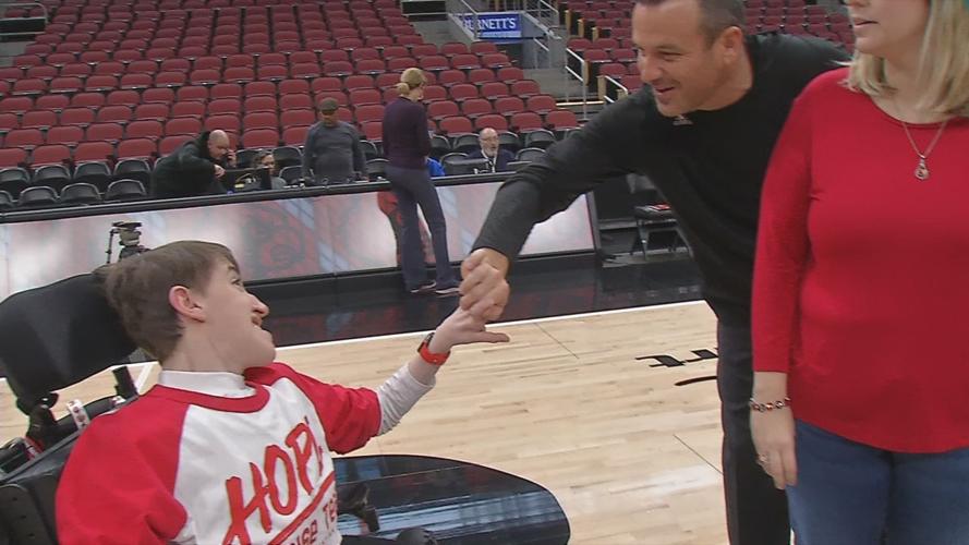 U of L women's basketball coach Jeff Walz greets Travis, a member of the H.O.P.E. Choir