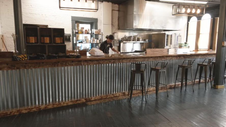 Zechariah Maxey works behind the counter at Leaven Bakery