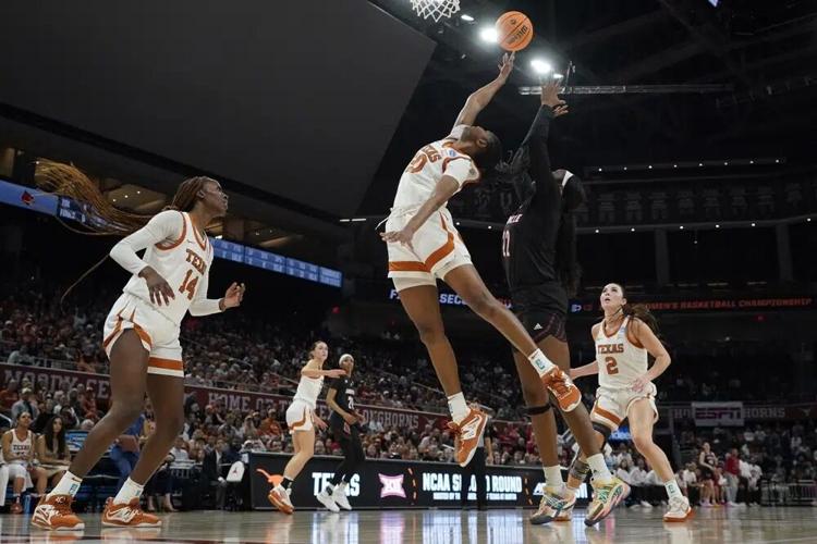 Texas forward Khadija Faye and Louisville forward Liz Dixon reach for a rebound.jpg