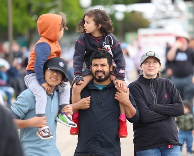 Man holds up child on shoulder.JPG