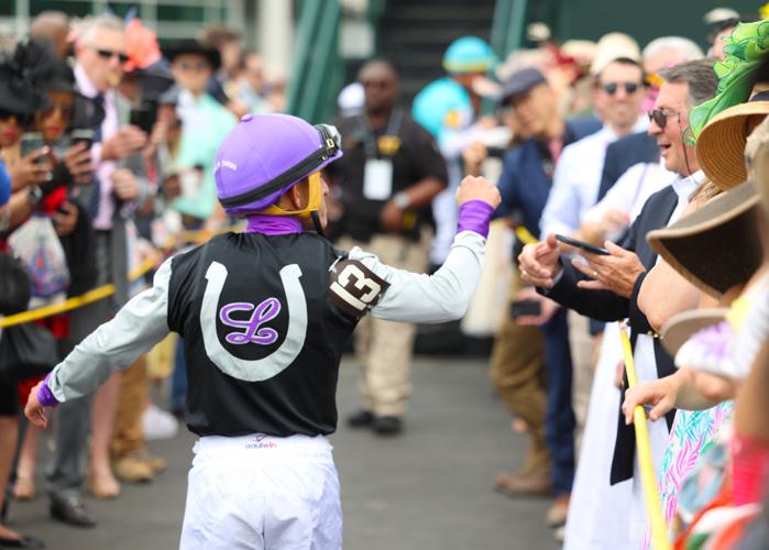 Jockey fist bumps person in crowd.JPG