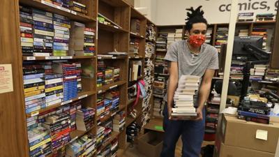 Dan Loftus carries books at Half Price Books.jpeg