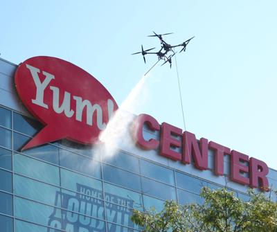Drone washer cleans Yum logo.JPG