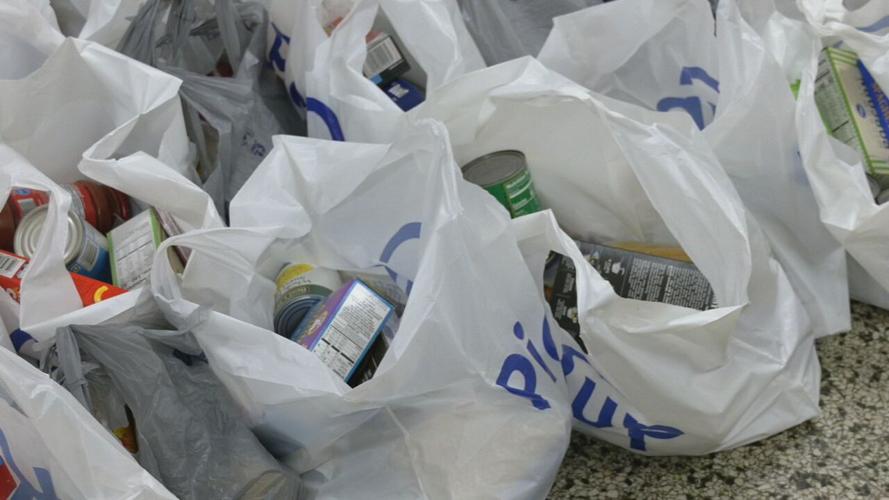 Volunteers assemble food bags, hygiene kits at La Casita Center 4-7-23