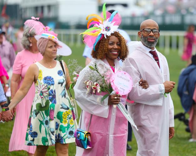 Couple walks together during Survivors Parade.JPG