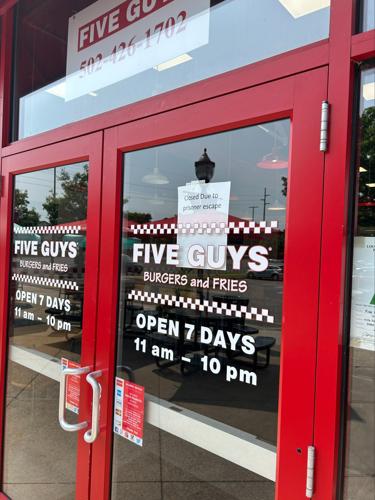 A sign on the door of a store at The Paddock Shoppes during escaped inmate search on May 18, 2023