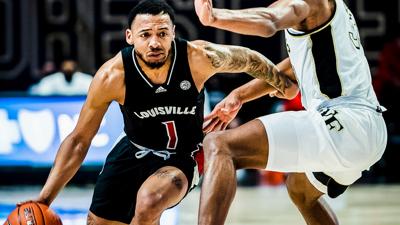 Louisville guard Carlik Jones dribbles past a Wake Forest defender