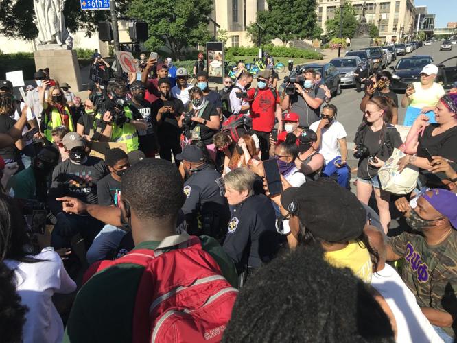 Officers kneel with crowd downtown 6-1-20