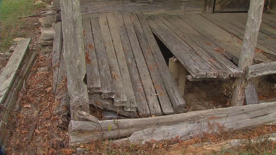 Porch on historic cabin falling through