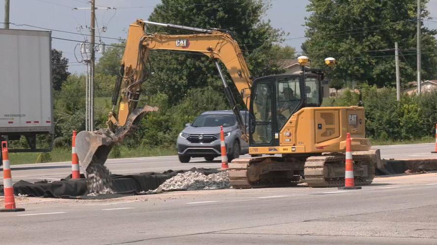 Construction crews work to add a second turning lane at Patriot Parkway and Ring Road