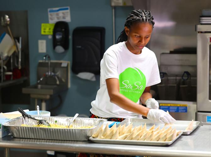 Sarah Kimeu prepares food at Sasa Samosa Kitchen.jpg