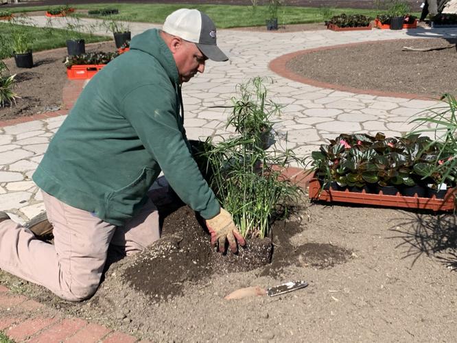 Greenhouse Crew planting near paddock at Churchill Downs