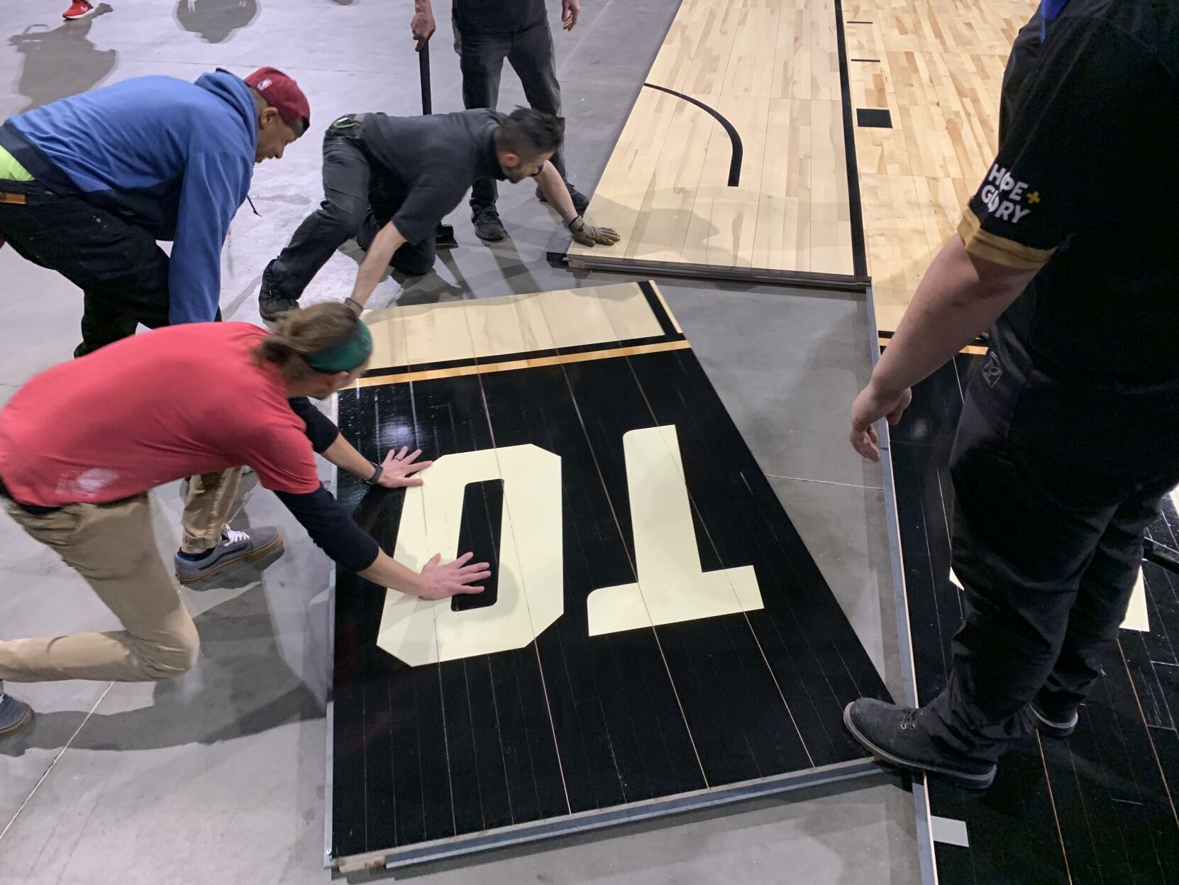 NCAA FLOOR  BEING INSTALLED AT YUM CENTER 3-21-2023 (7).JPG