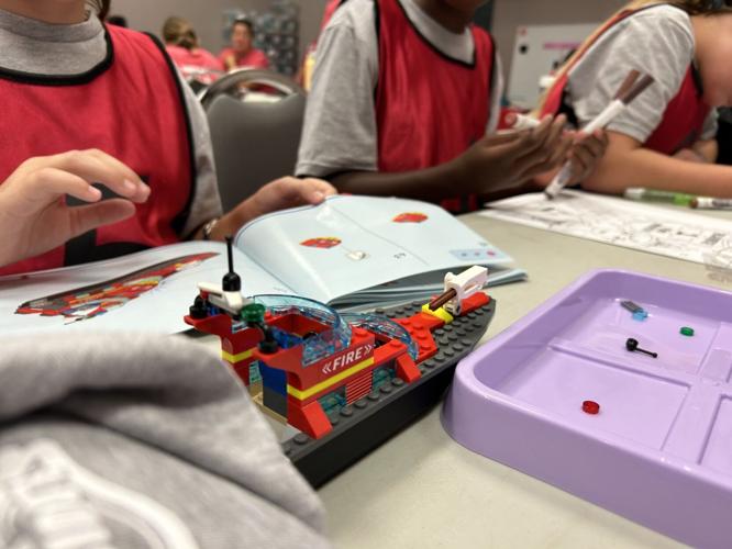 Around two dozen young girls participate in the third annual Lesley Prather Empowerment Camp at the Louisville Fire Training Academy
