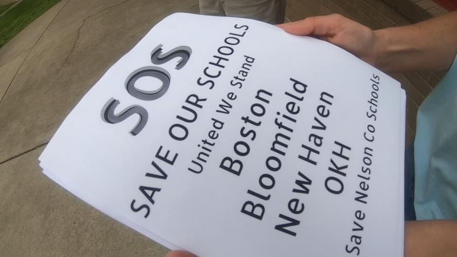Signs saying "Save Our Schools" before a community meeting at Bloomfield Elementary