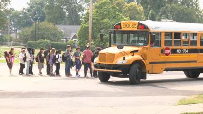 JCPS students wait in line to board bus - 8.21.23