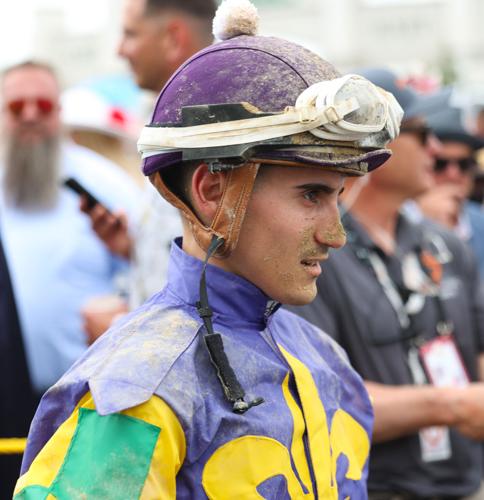 Muddy jockey walks to Paddock.JPG