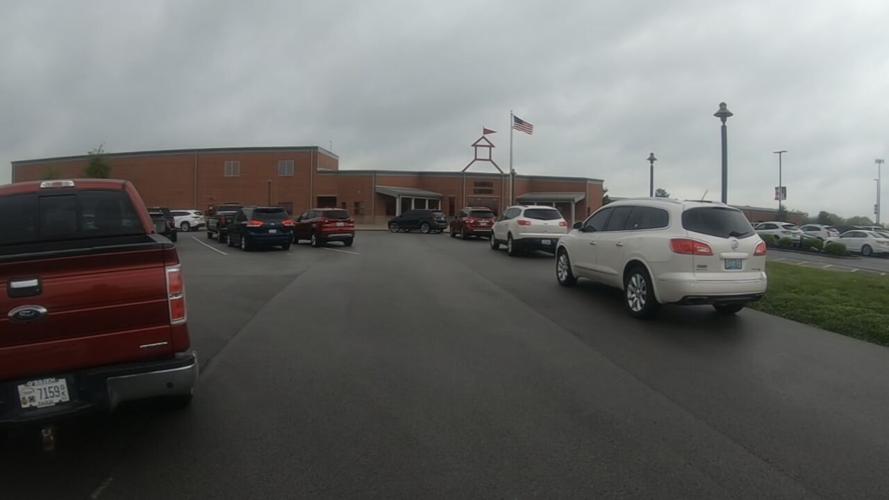 Cars parked outside Bloomfield Elementary in Bloomfield, Ky., ahead of a community meeting