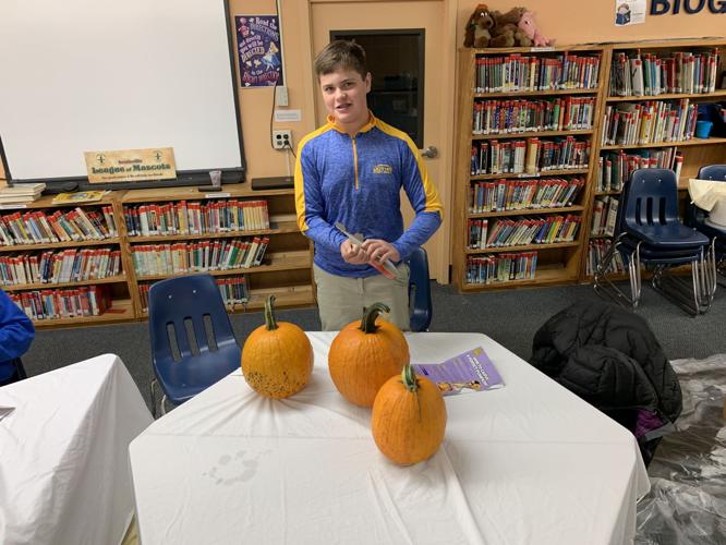 Jack O Lantern Stroll - Student in front of Pumpkin.jpeg