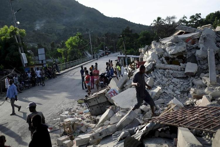 Haiti Earthquake - residents walk through rubble