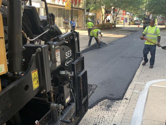 Louisville Metro Public Works crews pave a downtown Louisville road on July 26, 2023