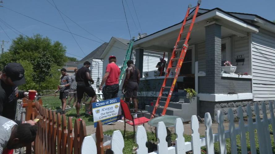 University of Louisville football players help repair a home in the Portland neighborhood