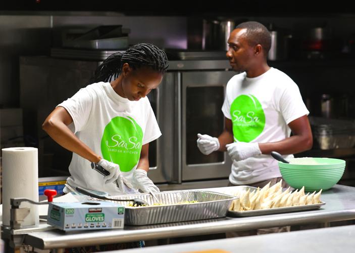 Sarah Kimeu preps food at Sasa Samosa Kitchen.jpg