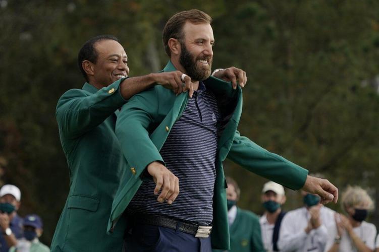 Tiger Woods helps Masters' champion Dustin Johnson with his green jacket
