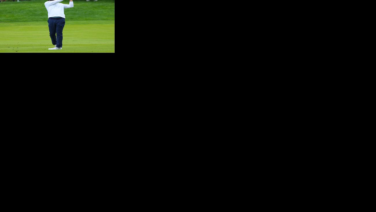 Scottie Scheffler hits an iron on fairway.JPG