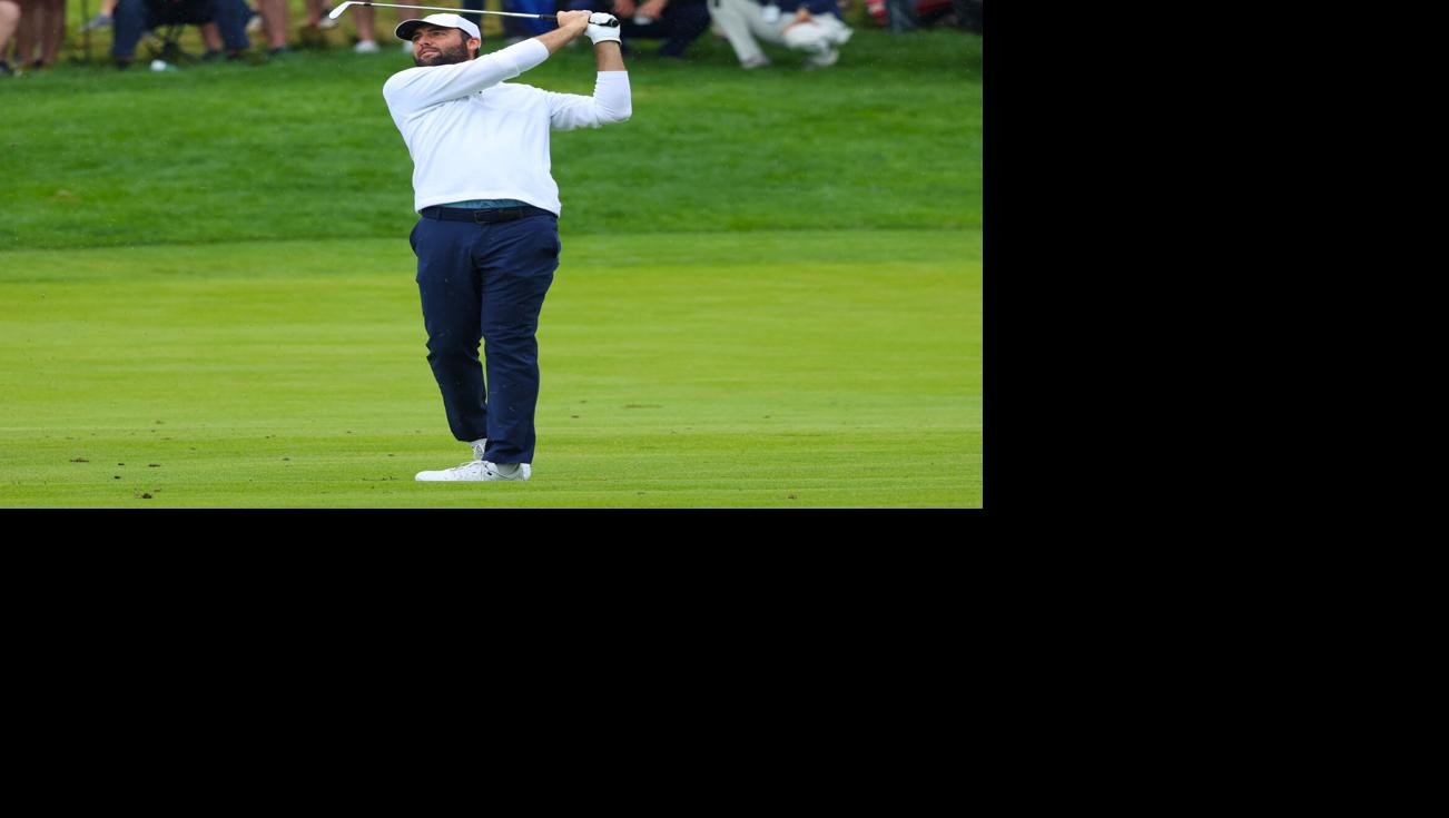 Scottie Scheffler hits an iron on fairway.JPG