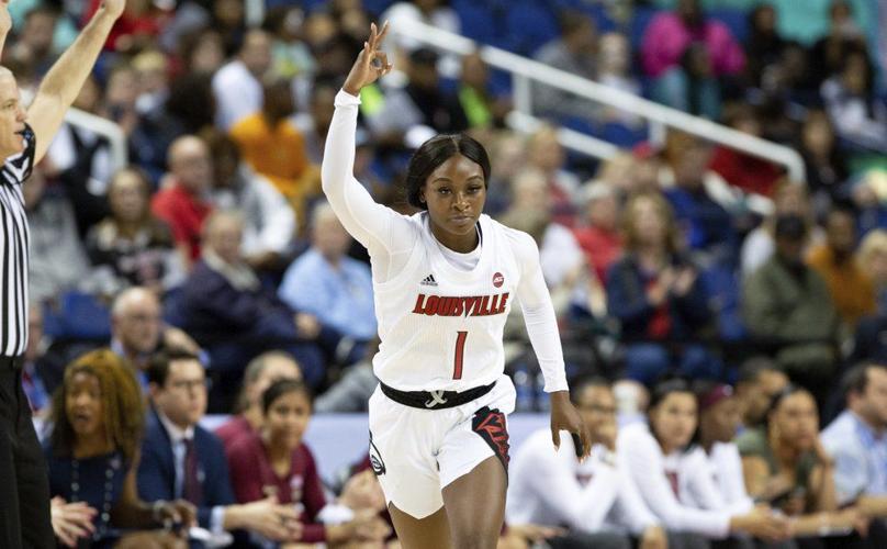 Louisville's Dana Evans (1) reacts after hitting a 3-pointer