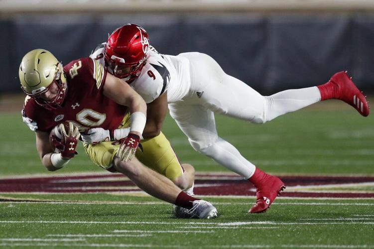 Louisville linebacker C.J. Avery (9) tackles Boston College tight end Hunter Long