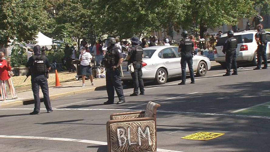 Anti-eviction protest LMPD standing in street 8-8-20