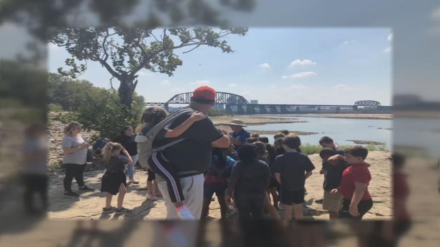 Tully Elementary teacher Jim Freeman carries 10-year-old Ryan Neighbors on his back for a school field trip