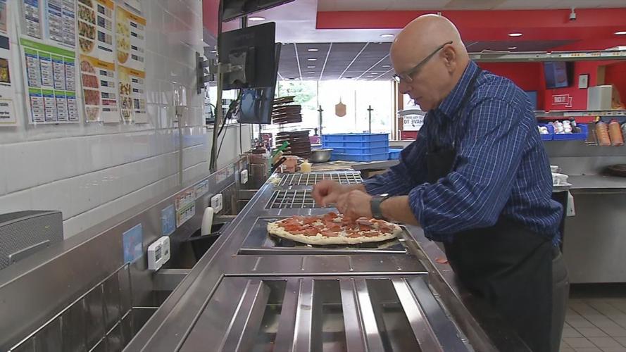 Tom Reynolds works in one of his Domino's stores
