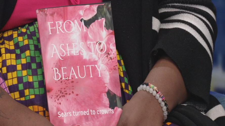 Marie-Ange Mbumba with her memoir on human trafficking