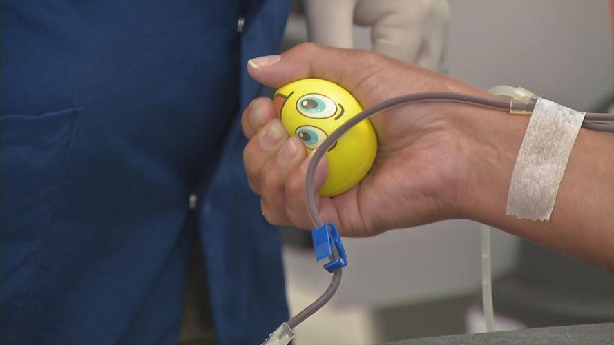 Woman squeezing stress ball at WDRB blood drive